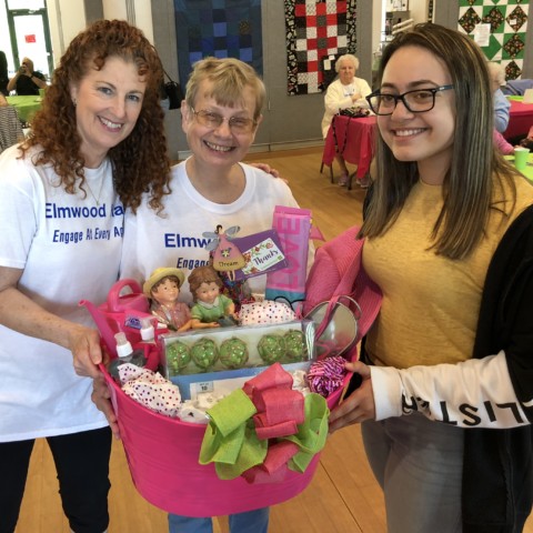 Broadview Middle School Volunteer Camile presents Kathy with Door Prize - Older Americans Month 2018